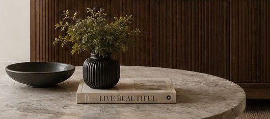 Marble coffee table styled with a vase and book